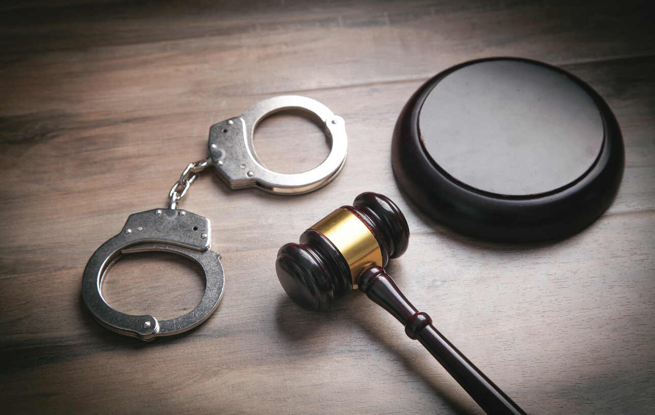 Criminal Defense Attorney in Cobb County Criminal handcuffs and lawyer gavel representing need of Criminal Defense Attorney in Cobb County
