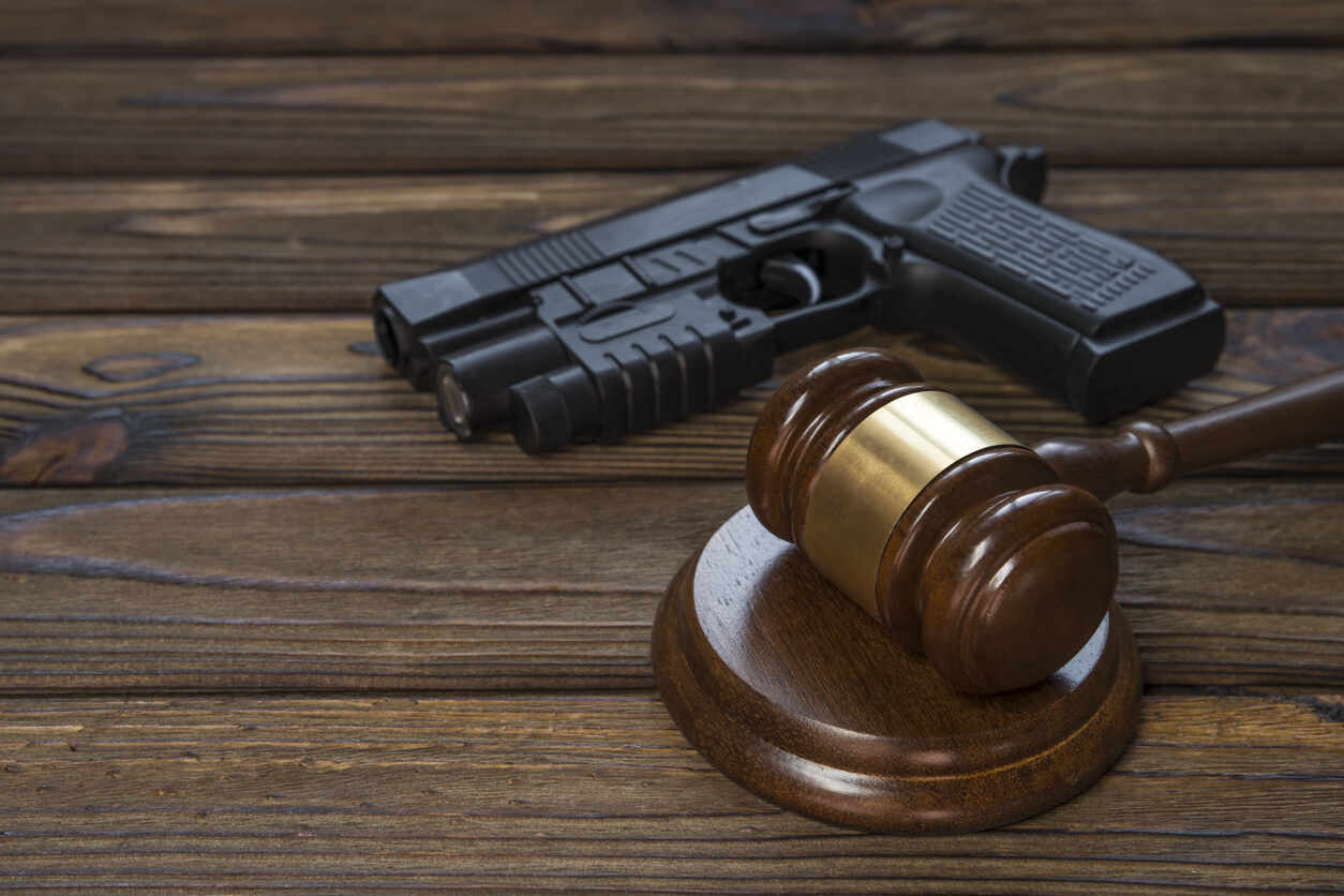 Criminal Defense Attorney in Fulton County Criminal defense attorney gavel and handgun symbolizing legal representation and defense in Fulton County criminal cases.