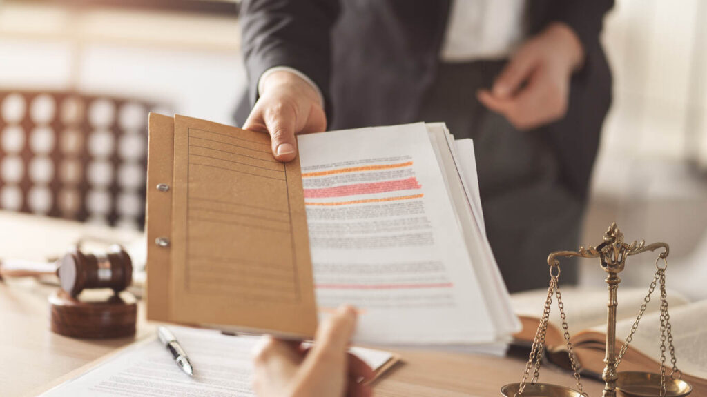 Attorney handing over legal documents in a firearm offense case